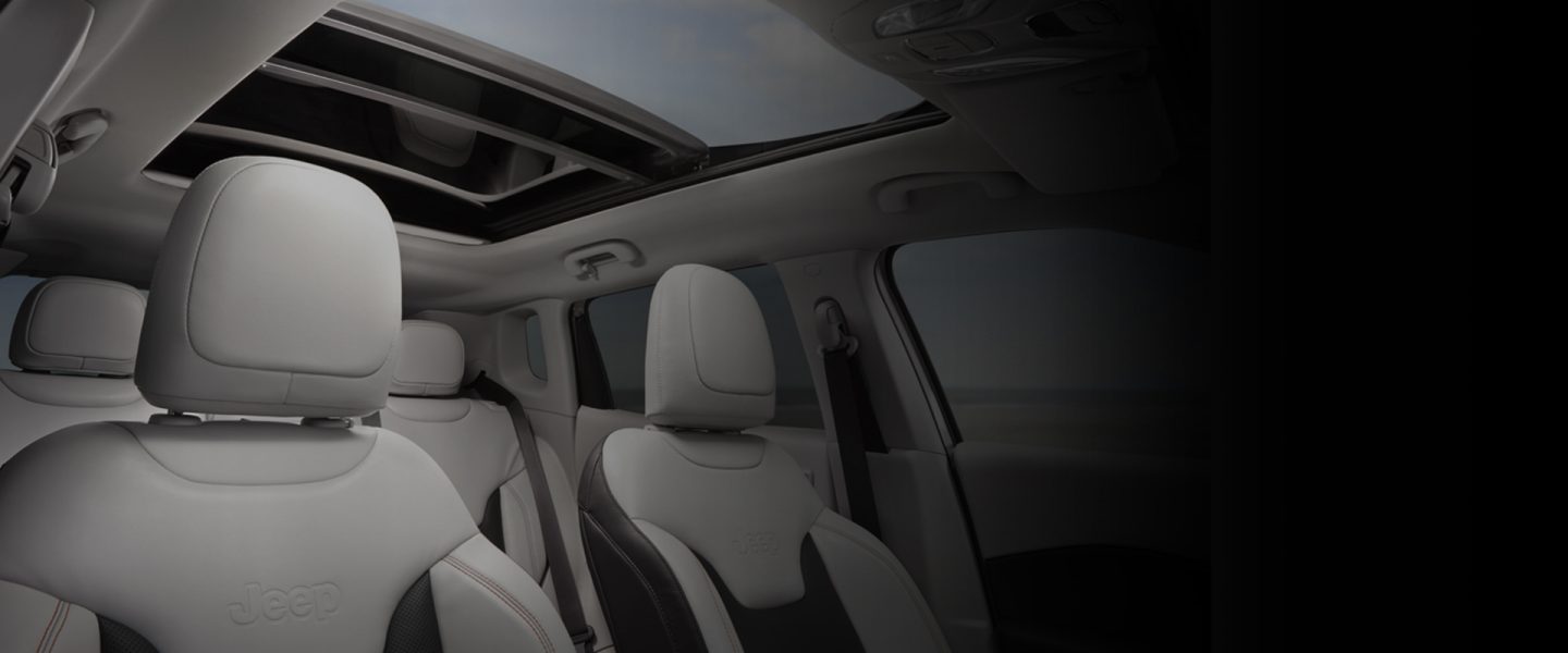 The interior of the 2020 Jeep Compass with the sunroof and front seat headrests visible.