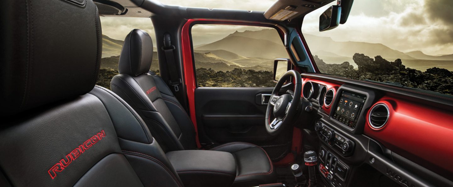 An interior view of the red accent stitching on the seats in the 2020 Jeep Wrangler Rubicon.
