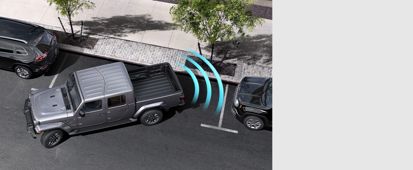 The 2021 Jeep Gladiator Overland with illustrated sensors monitoring the area behind the rear bumper, detecting the curb as it parallel parks.