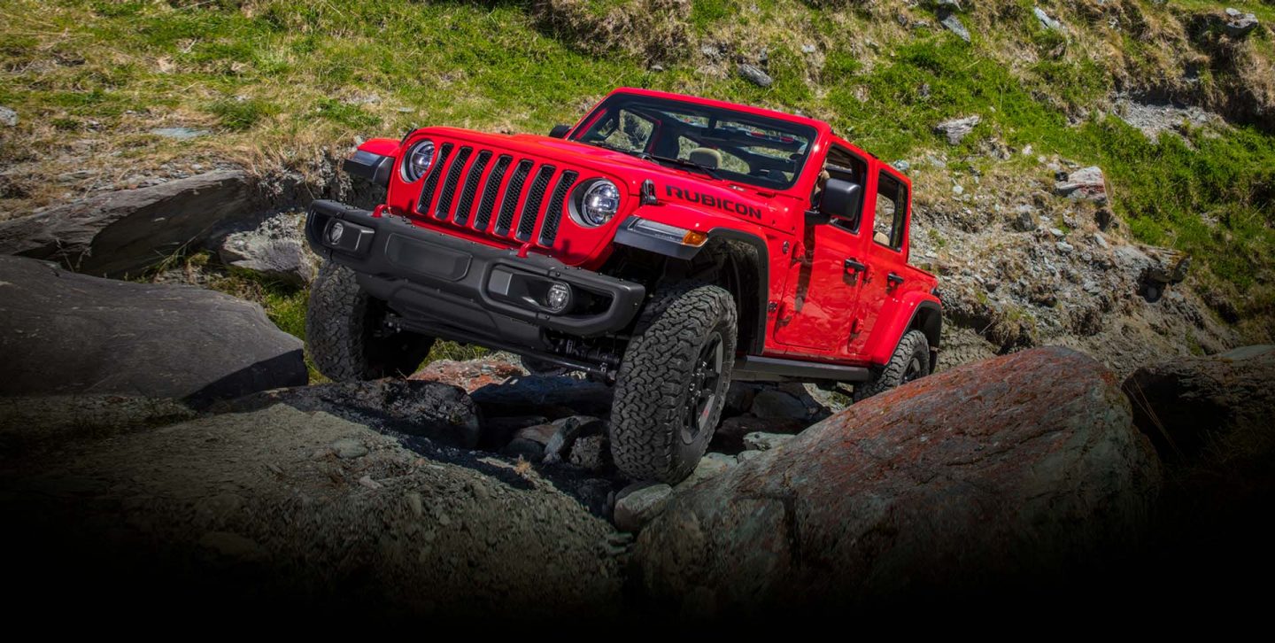 The 2022 Jeep Wrangler Rubicon climbing a steep, rocky slope.